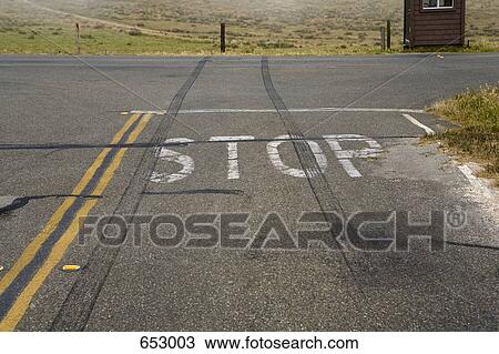 Tire marks skidding across a Stop Sign View Large Photo Image Stock Image - Tire marks skidding across a Stop Sign. Fotosearch