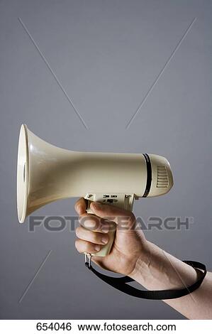 Stock Photograph - A hand holding a megaphone. Fotosearch