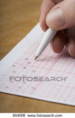 A hand marking a lottery ticket View Large Photo Image Stock Photograph - A hand marking a lottery ticket. Fotosearch