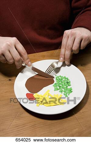 Stock Photography - A man eating dinner. Fotosearch