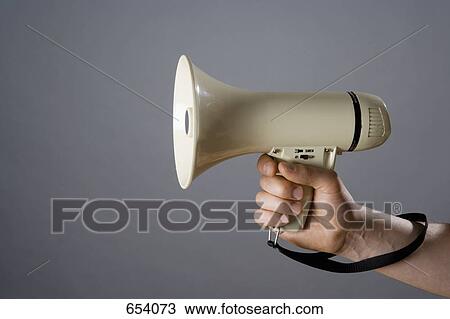 A man holding a megaphone View Large Photo Image Stock Image - A man holding a megaphone. Fotosearch