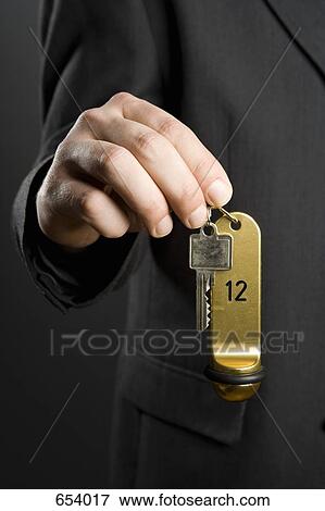 A man holding hotel key View Large Photo Image Stock Photo - A man holding hotel key. Fotosearch