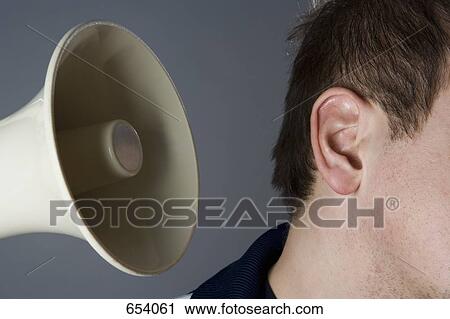 A megaphone next to a man’s ear View Large Photo Image Stock Image - A megaphone next to a man’s ear. Fotosearch