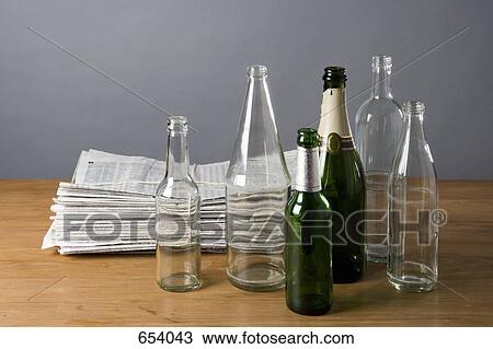 A stack of newspapers and empty bottles View Large Photo Image Stock Image - A stack of newspapers and empty bottles. Fotosearch