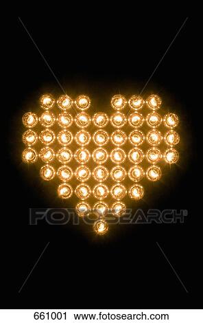 Stock Image - Heart symbol made with illuminated light bulbs. Fotosearch