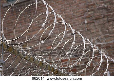 Razor wire atop a fence View Large Photo Image Picture - Razor wire atop a fence. Fotosearch