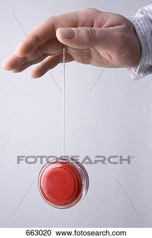 A human hand yo-yoing View Large Photo Image Stock Image - A human hand yo-yoing. Fotosearch