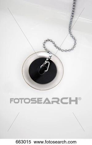 Stock Photography - A plugged drain in a sink with water. Fotosearch