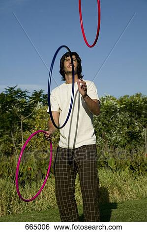A young man juggling hoops View Large Photo Image Stock Photograph - A young man juggling hoops. Fotosearch