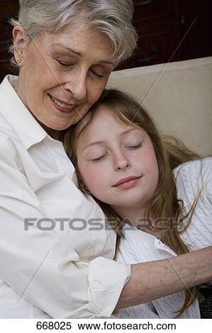 Stock Photography - A grandmother and granddaughter napping. Fotosearch