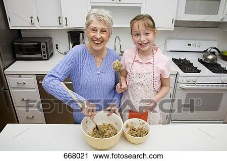 A grandmother and granddaughter preparing cookie dough View Large Photo Image Stock Image - A grandmother and granddaughter preparing cookie dough. Fotosearch