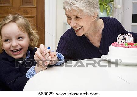 A grandson making mischief and his grandmother catching him View Large Photo Image Stock Photo - A grandson making mischief and his grandmother catching him. Fotosearch