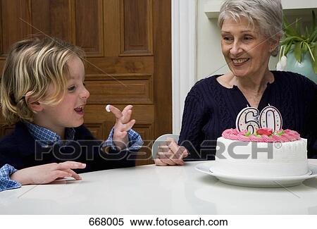 A Senior woman’s grandson eating icing from her birthday cake View Large Photo Image Stock Photography - A Senior woman’s grandson eating icing from her birthday cake. Fotosearch