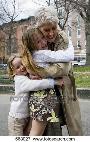 Grandchildren hugging their grandmother View Large Photo Image Stock Photo - Grandchildren hugging their grandmother. Fotosearch