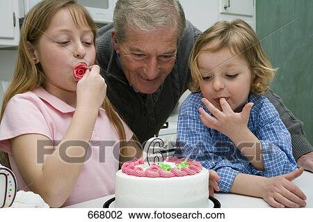 Grandfather celebrating a birthday with his grandchildren View Large Photo Image Stock Image - Grandfather celebrating a birthday with his grandchildren. Fotosearch