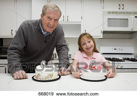 Grandfather celebrating a birthday with his granddaughter View Large Photo Image Stock Photo - Grandfather celebrating a birthday with his granddaughter. Fotosearch