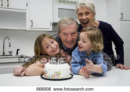 Stock Photo - Grandparents and grandchildren celebrating a birthday. Fotosearch