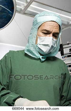Picture - A surgeon in the operating theatre. Fotosearch