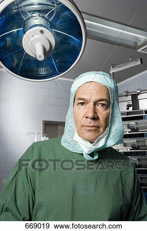 Stock Photo - A surgeon in the operating theatre. Fotosearch