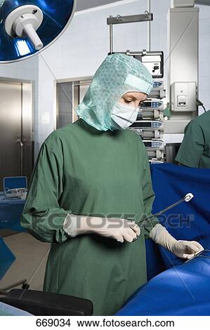 A surgeon operating on a patient View Large Photo Image Picture - A surgeon operating on a patient. Fotosearch