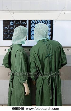 Two surgeons looking at x-rays View Large Photo Image Stock Photograph - Two surgeons looking at x-rays. Fotosearch