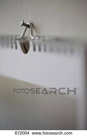 Close-up of nail holding up a spiral book View Large Photo Image Picture - Close-up of nail holding up a spiral book. Fotosearch