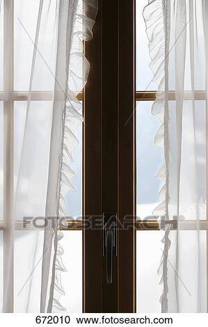 Stock Image - Windows with sheer curtain. Fotosearch