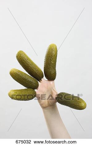 A hand with pickles on the fingers View Large Photo Image Stock Image - A hand with pickles on the fingers. Fotosearch