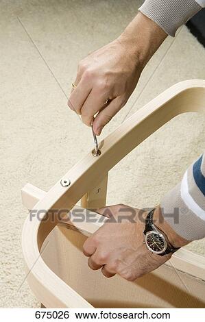 A man using an Allen wrench on a piece of furniture View Large Photo Image Stock Photograph - A man using an Allen wrench on a piece of furniture. Fotosearch