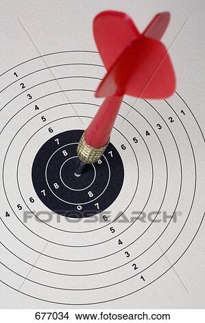 A dart hitting a bull's eye on a paper target View Large Photo Image Picture - A dart hitting a bull's eye on a paper target. Fotosearch