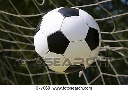 A soccer ball going into the net View Large Photo Image Stock Photo - A soccer ball going into the net. Fotosearch
