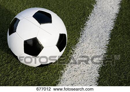Stock Image - A soccer ball on a soccer field. Fotosearch
