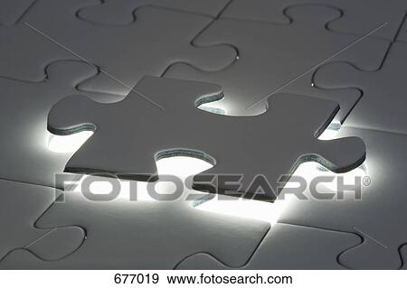 Stock Photo - Final piece to a jigsaw puzzle. Fotosearch