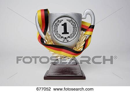 First place trophy cup wrapped in a sash with the German flag colors View Large Photo Image Stock Image - First place trophy cup wrapped in a sash with the German flag colors. Fotosearch
