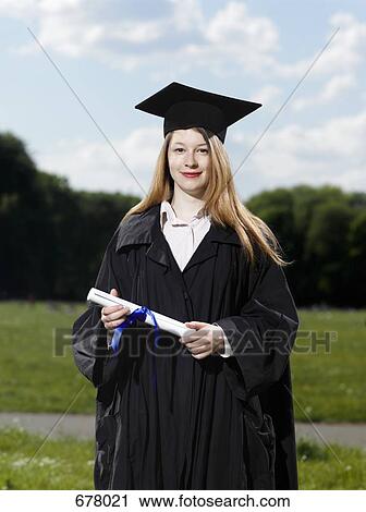 A female graduate holding a diploma View Large Photo Image Stock Image - A female graduate holding a diploma. Fotosearch