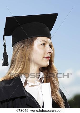 A female graduate holding a diploma View Large Photo Image Stock Photo - A female graduate holding a diploma. Fotosearch