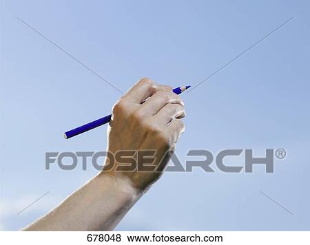 A human hand holding a blue colored pencil View Large Photo Image Stock Photo - A human hand holding a blue colored pencil. Fotosearch