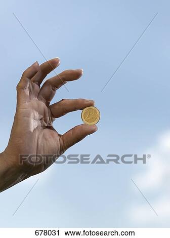 A human hand holding a two euro coin View Large Photo Image Stock Image - A human hand holding a two euro coin. Fotosearch