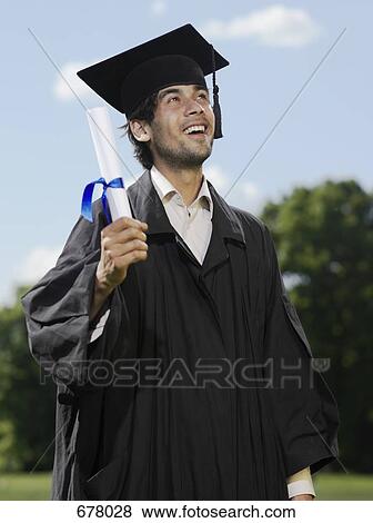 Stock Photo - A male graduate holding a diploma. Fotosearch