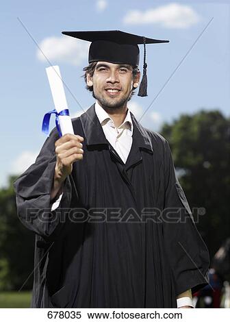 Stock Photography - A male graduate holding a diploma. Fotosearch
