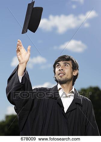 A male graduate throwing his mortar board in the air View Large Photo Image Stock Photo - A male graduate throwing his mortar board in the air. Fotosearch