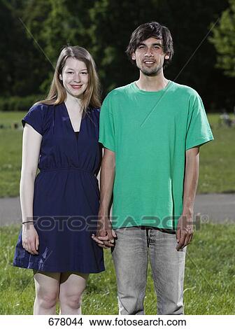 A young couple holding hands View Large Photo Image Picture - A young couple holding hands. Fotosearch