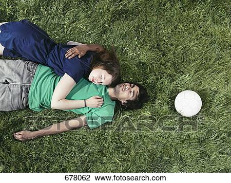 A young couple lying in the grass sleeping View Large Photo Image Stock Image - A young couple lying in the grass sleeping. Fotosearch