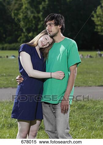 A young couple with their arms around each other View Large Photo Image Stock Photography - A young couple with their arms around each other. Fotosearch