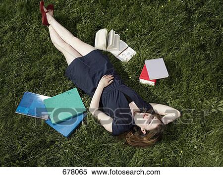 A young female student lying in the grass View Large Photo Image Stock Photography - A young female student lying in the grass. Fotosearch