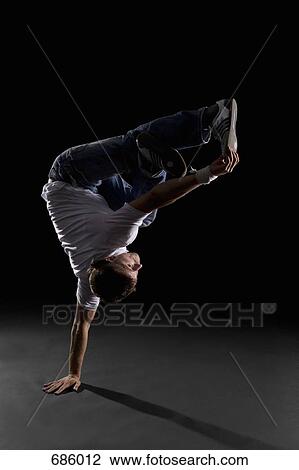 Stock Image - A B-boy doing a Freeze breakdance move. Fotosearch