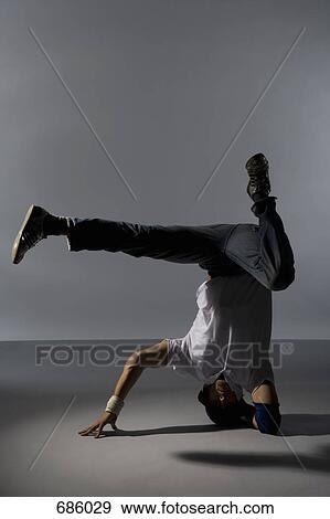 A B-boy doing a Headspin freeze breakdance move View Large Photo Image Stock Photo - A B-boy doing a Headspin freeze breakdance move. Fotosearch