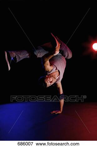 Stock Photo - A B-boy doing a One-handed Freeze breakdance move. Fotosearch