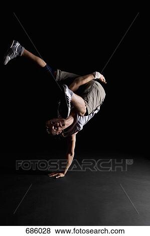 A B-boy doing a One-handed Freeze breakdance move View Large Photo Image Stock Photo - A B-boy doing a One-handed Freeze breakdance move. Fotosearch