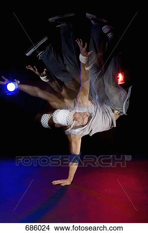 A B-boy doing a Pike Freeze breakdance move View Large Photo Image Picture - A B-boy doing a Pike Freeze breakdance move. Fotosearch